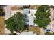 An aerial view shows the home has a metal roof and is surrounded by beautiful mature trees at 6609 Dartmouth N Ave, St Petersburg, FL 33710