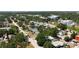 An aerial view showcases a charming neighborhood with tree-lined streets, homes, and lush greenery at 6609 Dartmouth N Ave, St Petersburg, FL 33710