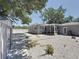 Property showcasing the spacious yard with gravel cover, plants and a gray storage shed at 6609 Dartmouth N Ave, St Petersburg, FL 33710