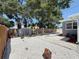 Fenced backyard with gravel, a storage shed, plants and trees at 6609 Dartmouth N Ave, St Petersburg, FL 33710