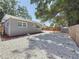Well-maintained backyard features low-maintenance rock landscaping, a storage shed, and fencing, providing privacy and functionality at 6609 Dartmouth N Ave, St Petersburg, FL 33710