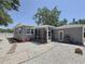 Spacious backyard featuring gravel, a screened in porch, an external door and a pathway at 6609 Dartmouth N Ave, St Petersburg, FL 33710