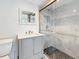 Beautiful bathroom featuring gray vanity, marble-tiled shower, and pebble floor at 6609 Dartmouth N Ave, St Petersburg, FL 33710