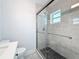 Modern bathroom featuring a glass-enclosed shower, marble tiles, and sleek fixtures at 6609 Dartmouth N Ave, St Petersburg, FL 33710