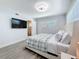 Bright bedroom features a large window, mounted TV, and ensuite bathroom at 6609 Dartmouth N Ave, St Petersburg, FL 33710