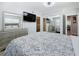 Comfortable bedroom with a large mirror, mounted TV, and ensuite bathroom at 6609 Dartmouth N Ave, St Petersburg, FL 33710