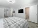 Spacious bedroom with gray floors, attached bath, and closet at 6609 Dartmouth N Ave, St Petersburg, FL 33710