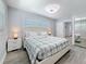 Bright bedroom with gray floors, closet, and side tables at 6609 Dartmouth N Ave, St Petersburg, FL 33710