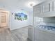 Charming bedroom with a bunk bed, laminate flooring, and bright beach themed wall art at 6609 Dartmouth N Ave, St Petersburg, FL 33710