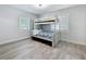 Cozy bedroom featuring a bunk bed, wood-look floors, and lots of natural light at 6609 Dartmouth N Ave, St Petersburg, FL 33710