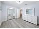 Bedroom features gray floors, closet and dresser storage at 6609 Dartmouth N Ave, St Petersburg, FL 33710