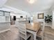 Cozy dining room adjoining kitchen featuring modern lighting and neutral wall colors at 6609 Dartmouth N Ave, St Petersburg, FL 33710