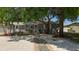 Attractive single-story house with mature trees in the front yard with white gravel at 6609 Dartmouth N Ave, St Petersburg, FL 33710