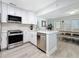 Open kitchen featuring stainless steel appliances, stone countertops, and seamless transition to the dining area at 6609 Dartmouth N Ave, St Petersburg, FL 33710
