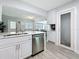 Modern kitchen with stainless steel appliances and gray-tone backsplash at 6609 Dartmouth N Ave, St Petersburg, FL 33710