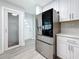 Modern kitchen with stainless steel appliances, white cabinetry, pantry and wood-look floors at 6609 Dartmouth N Ave, St Petersburg, FL 33710