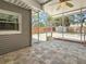 Screened patio featuring a tile floor, fan, and view of the fenced backyard, perfect for relaxing and enjoying the outdoors at 6609 Dartmouth N Ave, St Petersburg, FL 33710