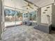 Enclosed porch with ceiling fan and tile flooring, perfect for outdoor relaxation and entertaining at 6609 Dartmouth N Ave, St Petersburg, FL 33710