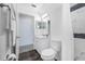 Bathroom featuring stylish vanity, toilet, and shower with stone-look flooring and modern fixtures at 7080 Nicole Ln, Largo, FL 33771