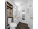 Bathroom featuring dark wood floors, toilet with cabinet, and white vanity at 7080 Nicole Ln, Largo, FL 33771