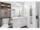 Bathroom with built-in shelving, white vanity, and decorative mirror at 7080 Nicole Ln, Largo, FL 33771