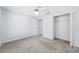 Spacious bedroom features a walk-in closet, neutral carpeting, and a ceiling fan at 7080 Nicole Ln, Largo, FL 33771