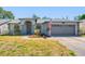 Inviting single Gathering home with manicured lawn, arched entryway and two car garage at 7080 Nicole Ln, Largo, FL 33771