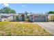 Inviting single Gathering home with manicured lawn, arched entryway and two car garage at 7080 Nicole Ln, Largo, FL 33771