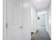 Carpeted hallway showing entryways to the bedroom and bathroom at 7080 Nicole Ln, Largo, FL 33771
