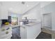 Bright kitchen with white cabinets, stainless steel appliances, and a breakfast bar at 7080 Nicole Ln, Largo, FL 33771