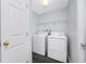 Cozy laundry room equipped with a washer, dryer, and overhead storage shelf at 7080 Nicole Ln, Largo, FL 33771