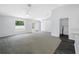 Living room with carpet, a ceiling fan and view to laundry room at 7080 Nicole Ln, Largo, FL 33771