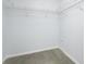 Walk-in closet provides ample storage with built-in shelving and neutral carpeting at 7080 Nicole Ln, Largo, FL 33771