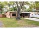 A charming single-story home featuring a large tree in the front yard at 7141 56Th N St, Pinellas Park, FL 33781