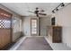 Bright sunroom with fan, lattice windows, door, and a rustic accent table to one side at 7141 56Th N St, Pinellas Park, FL 33781