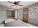 Cozy sunroom with ceiling fan, lattice windows, and unique doors. A wonderful space for relaxation at 7141 56Th N St, Pinellas Park, FL 33781