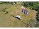 Sprawling property featuring a private pool, large fenced yard, and a detached barn or workshop at 7509 Hackamore Rd, Zephyrhills, FL 33541