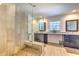 Modern bathroom featuring a glass shower with a built-in bench and pebble floor at 7509 Hackamore Rd, Zephyrhills, FL 33541