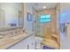 Bathroom featuring a tiled shower with a glass door and a granite vanity top at 7509 Hackamore Rd, Zephyrhills, FL 33541