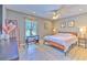 Bedroom featuring a wood-look floor, desk, ceiling fan, and warm paint color at 7509 Hackamore Rd, Zephyrhills, FL 33541