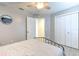 Cozy bedroom featuring a ceiling fan, ensuite bath, double door closet and light wood flooring at 7509 Hackamore Rd, Zephyrhills, FL 33541