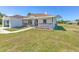 Inviting single-Gathering home featuring a covered front porch and attached garage at 7509 Hackamore Rd, Zephyrhills, FL 33541