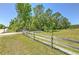 Beautiful front yard and wood fence in a rural setting at 7509 Hackamore Rd, Zephyrhills, FL 33541