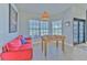 Bright game room with large windows, tile flooring, and a foosball table at 7509 Hackamore Rd, Zephyrhills, FL 33541