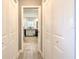 Hallway with hardwood floors, closet, and a bright room at the end at 7509 Hackamore Rd, Zephyrhills, FL 33541