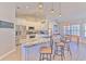 Kitchen featuring a granite island, stainless steel appliances, and modern lighting at 7509 Hackamore Rd, Zephyrhills, FL 33541