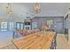 Open-concept living room featuring a fireplace, modern lighting, and a dining area at 7509 Hackamore Rd, Zephyrhills, FL 33541