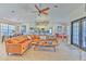 Open-concept living room with modern finishes, a fireplace, and access to the game room at 7509 Hackamore Rd, Zephyrhills, FL 33541