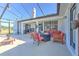 Spacious covered patio with a fire pit and comfortable seating, ideal for outdoor living at 7509 Hackamore Rd, Zephyrhills, FL 33541