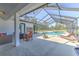 Relaxing screened-in pool area with outdoor furniture, perfect for entertaining guests at 7509 Hackamore Rd, Zephyrhills, FL 33541